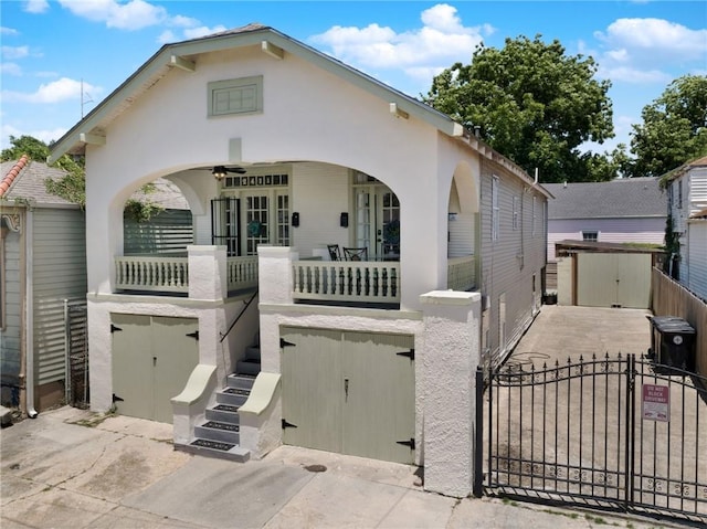 2409-11 St Ann St, New Orleans, LA 70119 - view of front of property featuring a porch, a gate, and an attached garage