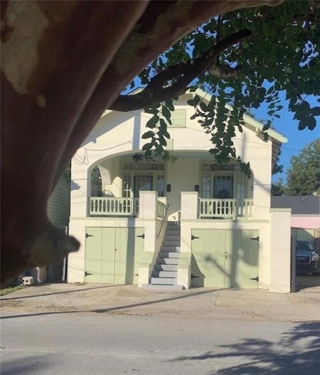 2409-11 St Ann St, New Orleans, LA 70119 - view of front of house with stairway and covered porch