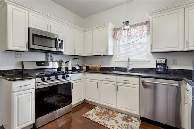 2409-11 St Ann St, New Orleans, LA 70119 - kitchen with appliances with stainless steel finishes, a sink, and white cabinetry