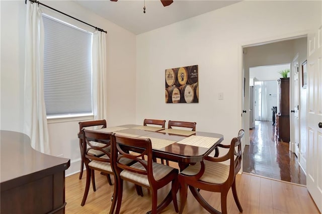 2409-11 St Ann St, New Orleans, LA 70119 - dining space featuring a ceiling fan, wood finished floors, and baseboards