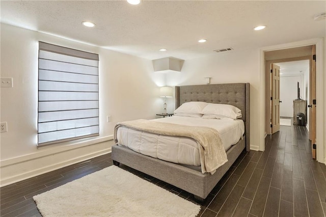2409-11 St Ann St, New Orleans, LA 70119 - bedroom featuring dark wood finished floors, baseboards, recessed lighting, and a textured ceiling