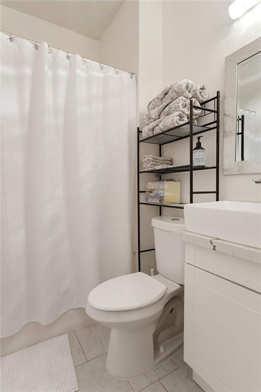 2409-11 St Ann St, New Orleans, LA 70119 - bathroom featuring toilet, vanity, marble finish floors, and shower / bath combination with curtain