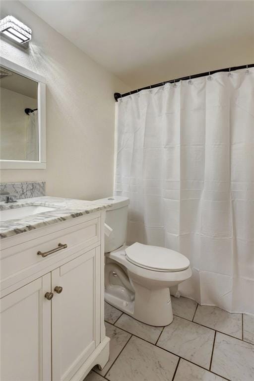 2409-11 St Ann St, New Orleans, LA 70119 - bathroom featuring marble finish flooring, toilet, and vanity