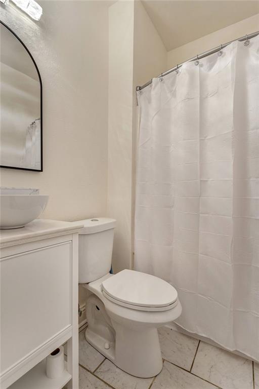 2409-11 St Ann St, New Orleans, LA 70119 - bathroom with tile patterned floors, toilet, and vanity