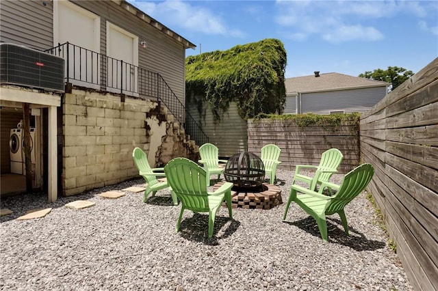 2409-11 St Ann St, New Orleans, LA 70119 - view of yard featuring an outdoor fire pit, stairway, cooling unit, and washing machine and clothes dryer