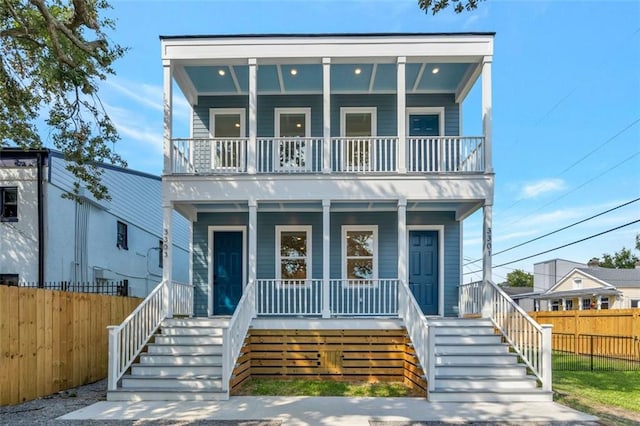 330103 S Saratoga St, New Orleans, LA 70115 - view of front of house with a balcony, a porch, and stairway