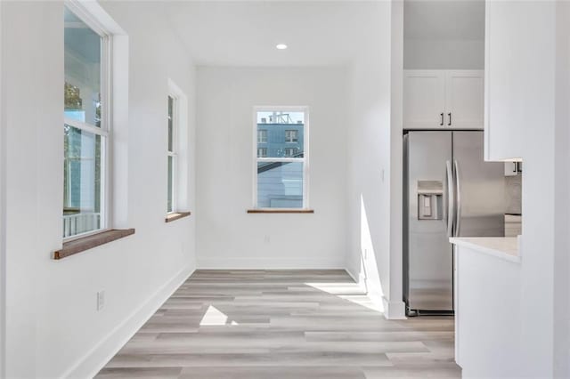 330103 S Saratoga St, New Orleans, LA 70115 - unfurnished dining area with baseboards, light wood finished floors, and recessed lighting