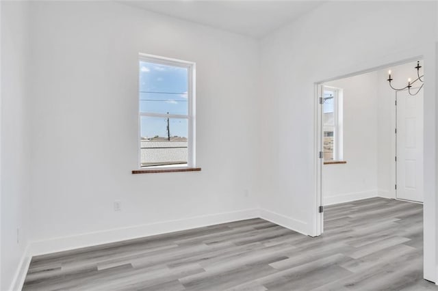 330103 S Saratoga St, New Orleans, LA 70115 - spare room featuring light wood-style floors and baseboards