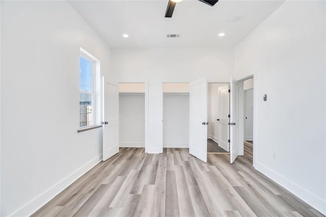 330103 S Saratoga St, New Orleans, LA 70115 - unfurnished bedroom featuring multiple closets, light wood finished floors, baseboards, recessed lighting, and a ceiling fan
