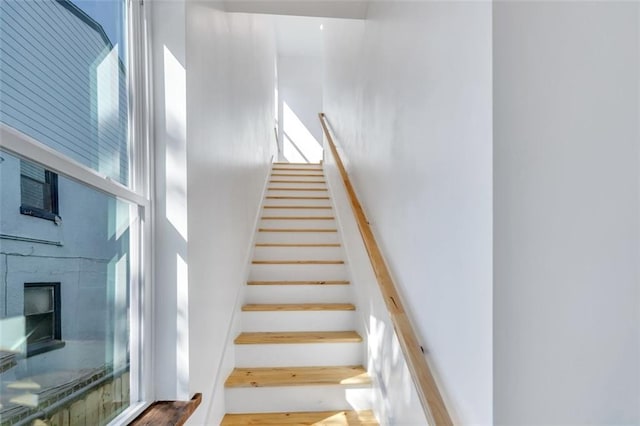 330103 S Saratoga St, New Orleans, LA 70115 - stairway featuring a high ceiling, wood finished floors, and a fireplace