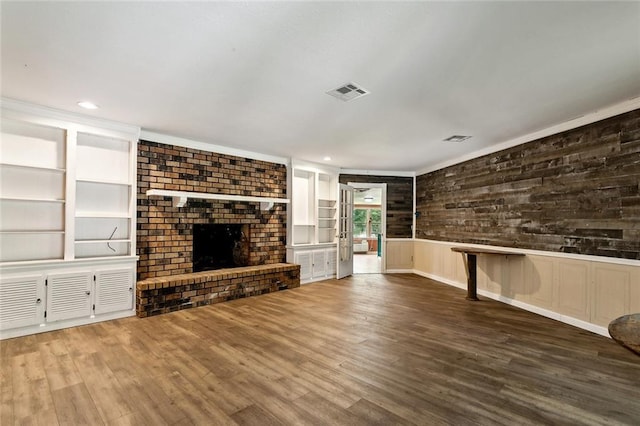 72430 Bullard St, Covington, LA 70435 - unfurnished living room featuring wood finished floors, a brick fireplace, recessed lighting, and a wainscoted wall