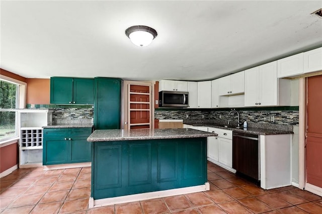 72430 Bullard St, Covington, LA 70435 - kitchen with stainless steel microwave, dishwashing machine, backsplash, light tile patterned flooring, and dark stone countertops