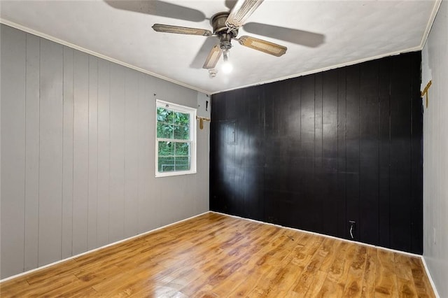 72430 Bullard St, Covington, LA 70435 - unfurnished room with wood finished floors, ceiling fan, wood walls, and crown molding