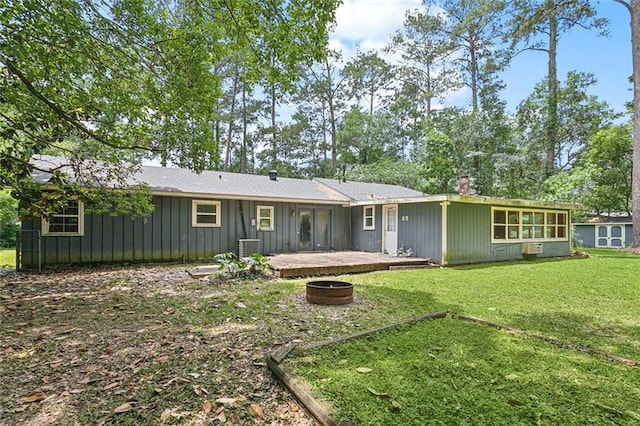 72430 Bullard St, Covington, LA 70435 - back of property featuring a lawn, a chimney, board and batten siding, and central AC unit
