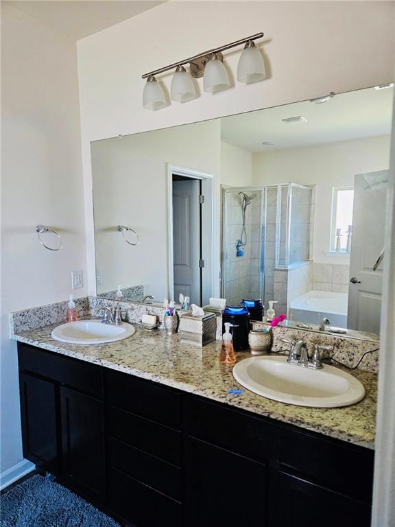1393 Shipyard Dr, Slidell, LA 70461 - full bathroom featuring a stall shower, double vanity, and a bath