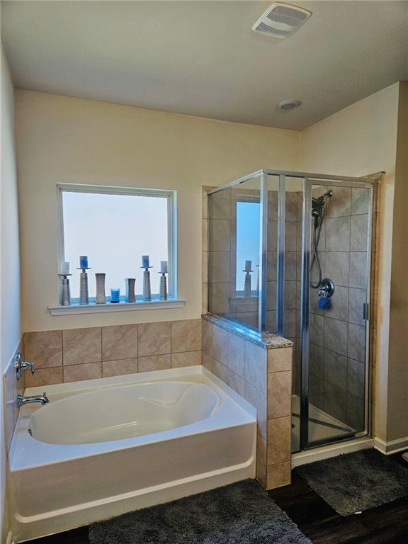 1393 Shipyard Dr, Slidell, LA 70461 - bathroom with a bath, a shower stall, and wood finished floors