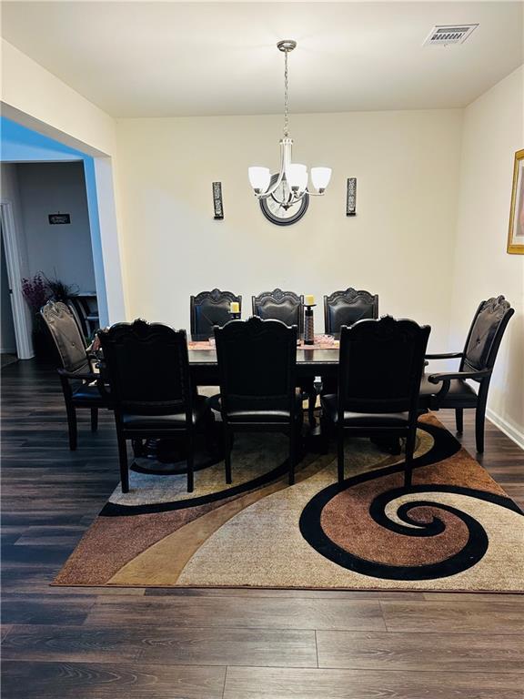 1393 Shipyard Dr, Slidell, LA 70461 - dining area featuring a chandelier and wood finished floors