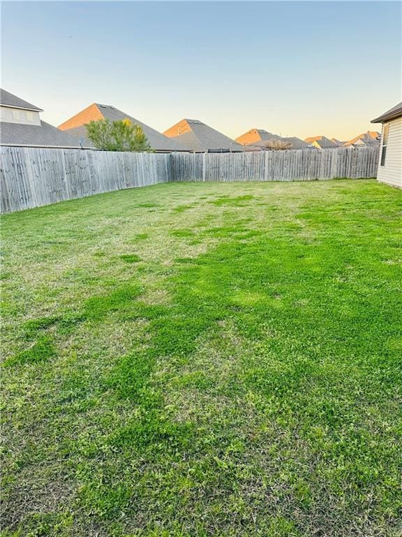 1393 Shipyard Dr, Slidell, LA 70461 - yard at dusk with a fenced backyard