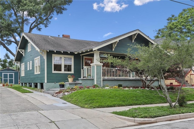 4462 Lafaye St, New Orleans, LA 70122 - bungalow-style home with covered porch, a front yard, a chimney, and a shingled roof