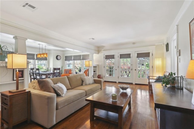 4462 Lafaye St, New Orleans, LA 70122 - living room with dark wood-style floors and decorative columns