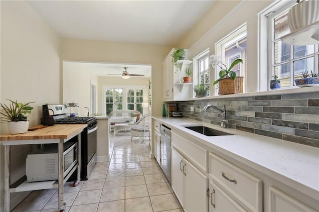 4462 Lafaye St, New Orleans, LA 70122 - kitchen featuring appliances with stainless steel finishes, a sink, healthy amount of natural light, and decorative backsplash
