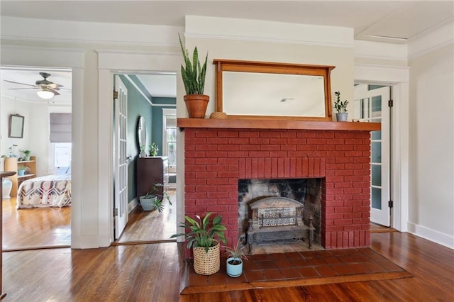 4462 Lafaye St, New Orleans, LA 70122 - living room featuring wood finished floors, crown molding, ceiling fan, a fireplace, and baseboards