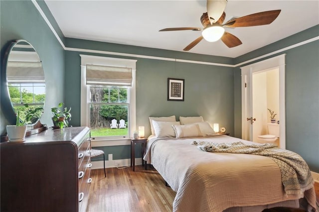 4462 Lafaye St, New Orleans, LA 70122 - bedroom with wood-type flooring, baseboards, a ceiling fan, and ensuite bathroom