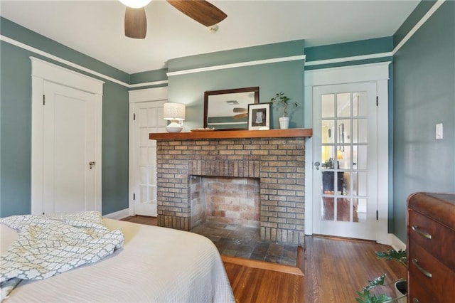 4462 Lafaye St, New Orleans, LA 70122 - bedroom with a fireplace, wood finished floors, and baseboards