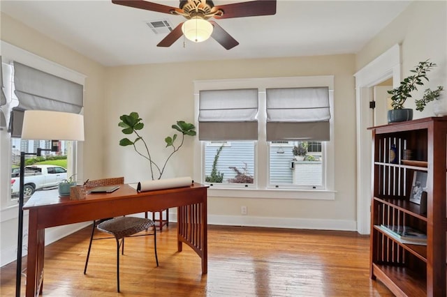 4462 Lafaye St, New Orleans, LA 70122 - home office featuring wood finished floors, ceiling fan, and baseboards