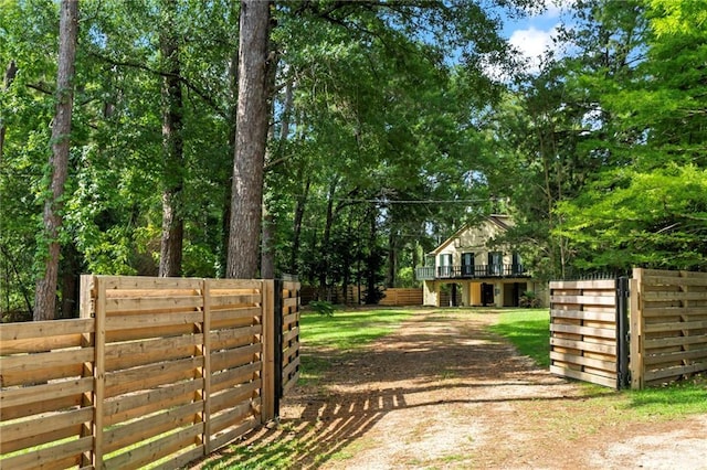 10152 Lawrence Rd, Hammond, LA 70403 - gate featuring stairs, a deck, and view of wooded area