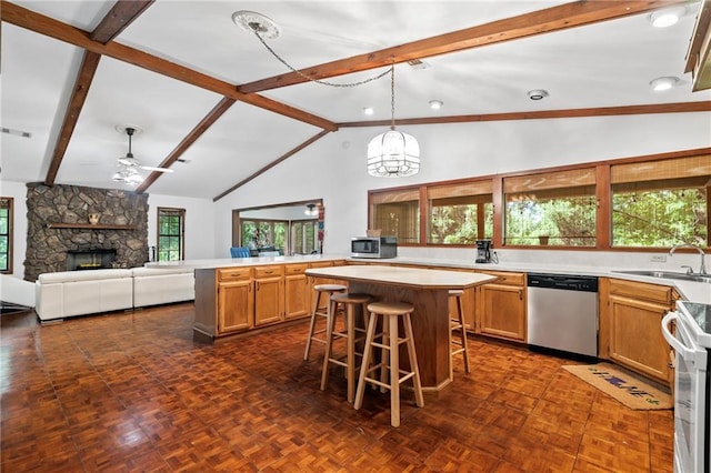 10152 Lawrence Rd, Hammond, LA 70403 - kitchen featuring appliances with stainless steel finishes, a sink, a kitchen island, open floor plan, and light countertops