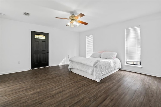 10152 Lawrence Rd, Hammond, LA 70403 - bedroom featuring multiple windows, dark wood-style floors, and baseboards