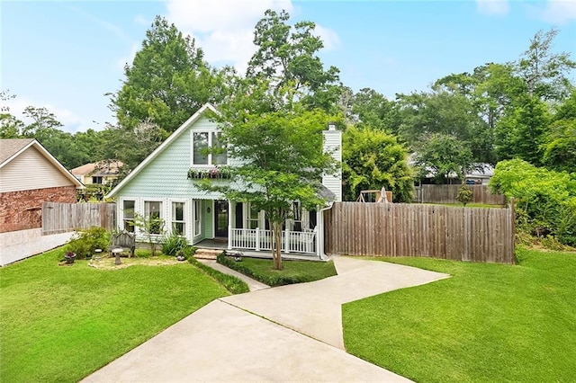 265 Cindy Lou Pl, Mandeville, LA 70448 - view of front of home with covered porch and a chimney