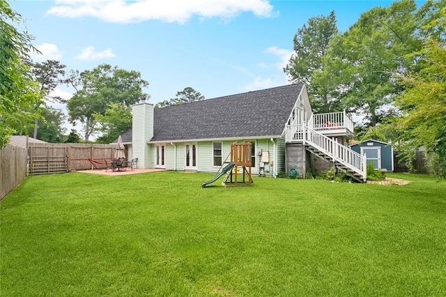 265 Cindy Lou Pl, Mandeville, LA 70448 - rear view of property featuring a chimney, stairs, roof with shingles, a patio, and a playground