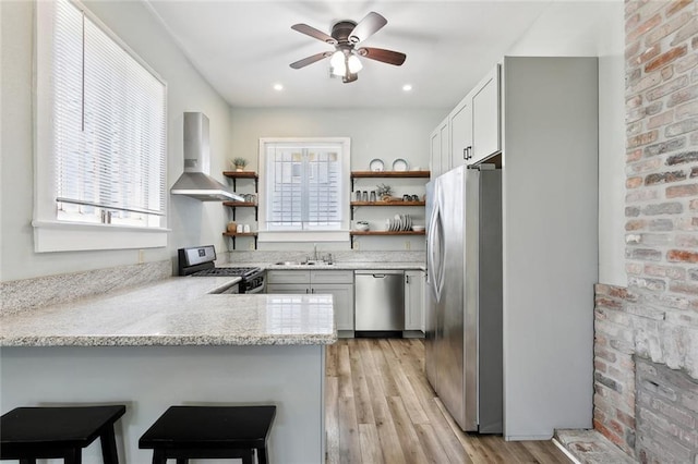 330406 Conti St, New Orleans, LA 70119 - kitchen featuring wall chimney range hood, appliances with stainless steel finishes, open shelves, a peninsula, and recessed lighting