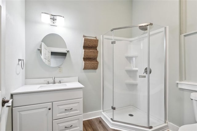 330406 Conti St, New Orleans, LA 70119 - bathroom featuring a shower stall, toilet, wood finished floors, baseboards, and vanity