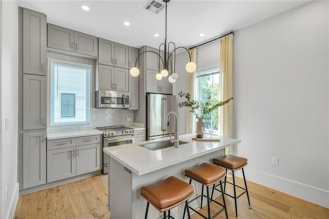 3431 Chartres St Unit 3, New Orleans, LA 70117 - kitchen with stainless steel appliances, gray cabinets, a sink, baseboards, and recessed lighting