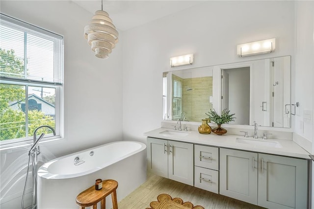 3431 Chartres St Unit 3, New Orleans, LA 70117 - bathroom featuring healthy amount of natural light, tiled shower, a freestanding bath, and double vanity