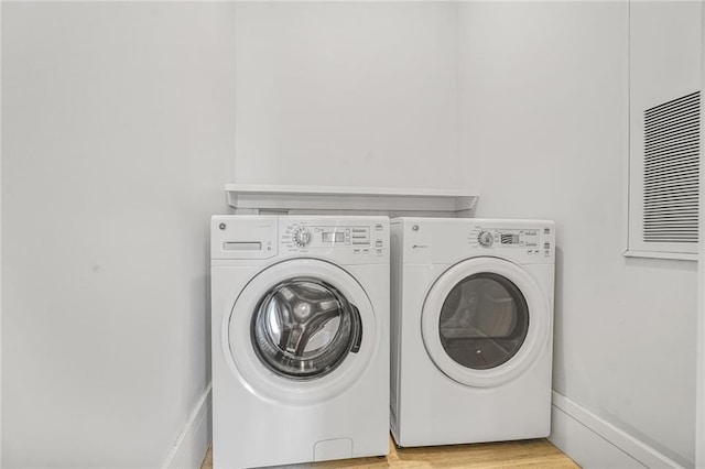 3431 Chartres St Unit 3, New Orleans, LA 70117 - laundry area with separate washer and dryer and light wood finished floors