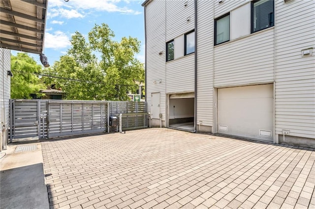 3431 Chartres St Unit 3, New Orleans, LA 70117 - view of patio / terrace featuring a gate, a garage, and decorative driveway