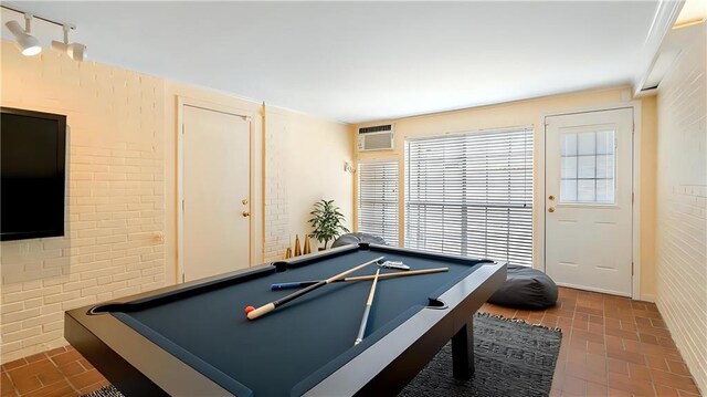 5000 Senac Dr, Metairie, LA 70003 - playroom featuring brick patterned flooring, billiards, and a wall mounted air conditioner