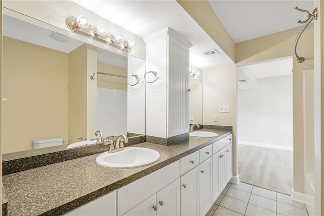 711921 Marshal Foch St, New Orleans, LA 70124 - full bathroom featuring double vanity, tile patterned flooring, toilet, a shower, and baseboards
