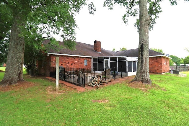 14370 Hickory Dr, Ponchatoula, LA 70454 - back of house featuring a sunroom, a chimney, brick siding, central AC, and a patio
