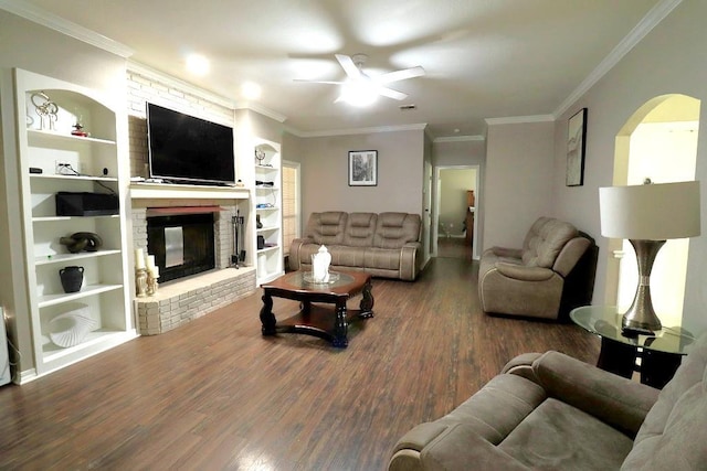 14370 Hickory Dr, Ponchatoula, LA 70454 - living area featuring a ceiling fan, arched walkways, wood finished floors, a brick fireplace, and ornamental molding