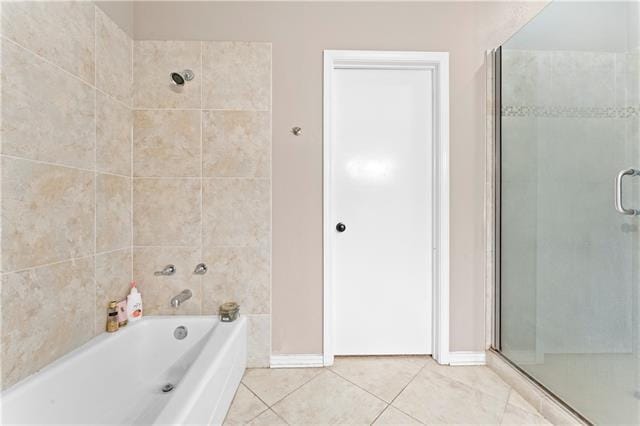 14370 Hickory Dr, Ponchatoula, LA 70454 - bathroom featuring a stall shower, tile patterned floors, a bath, and baseboards