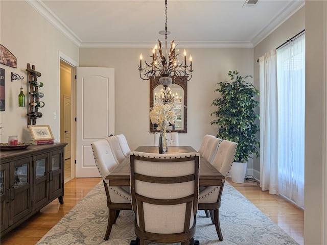 2044 S Lakeshore Blvd, Slidell, LA 70461 - dining room featuring a chandelier, light wood-type flooring, and ornamental molding