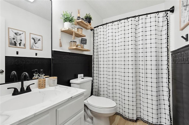 4824 Grand Bayou Dr, Marrero, LA 70072 - full bathroom with toilet, curtained shower, wood finished floors, vanity, and a textured ceiling