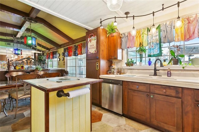 42 Richelle St, Waggaman, LA 70094 - kitchen featuring stainless steel dishwasher, a sink, decorative light fixtures, a center island, and brown cabinets