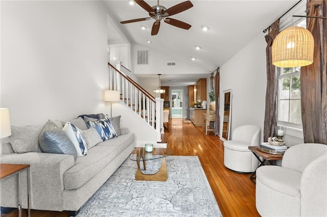 918 Harmony St, New Orleans, LA 70115 - living area with stairway, vaulted ceiling, ceiling fan, wood finished floors, and recessed lighting
