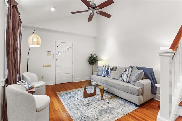 918 Harmony St, New Orleans, LA 70115 - living room featuring ceiling fan, wood finished floors, baseboards, and high vaulted ceiling
